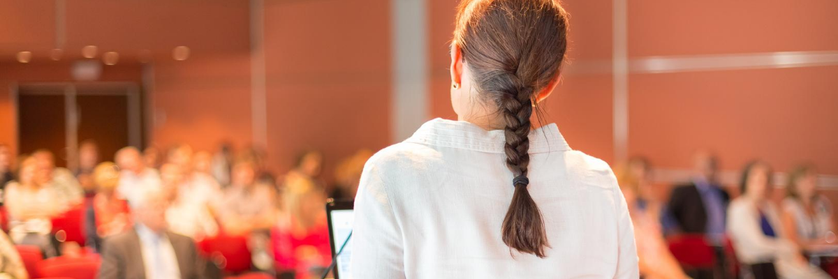 photo of woman teaching in a lecture hall